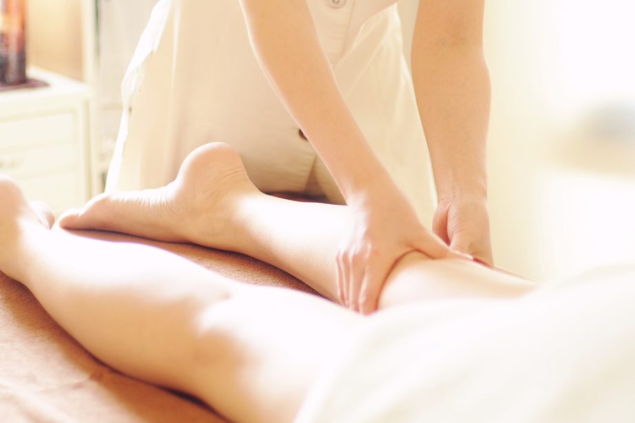 Woman receiving an aroma oil leg massage